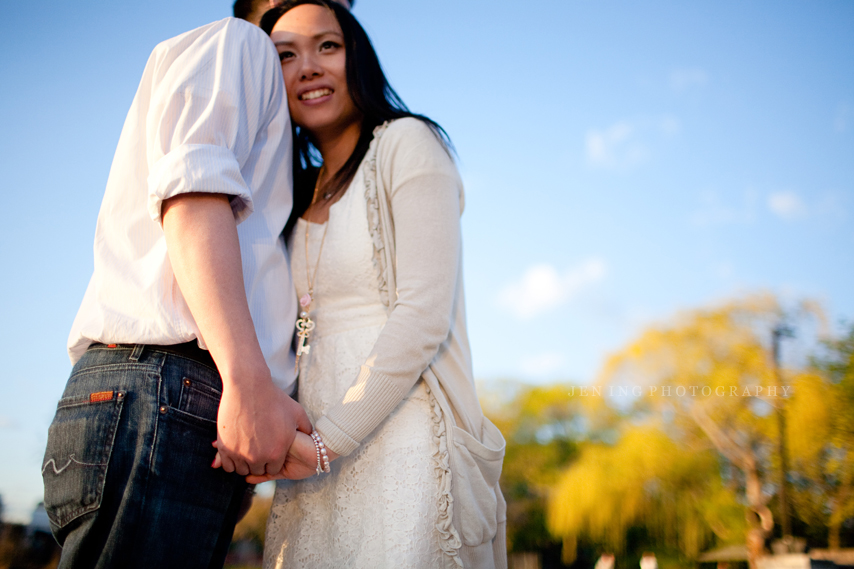 Boston engagement session on esplanade dock - couple snuggling