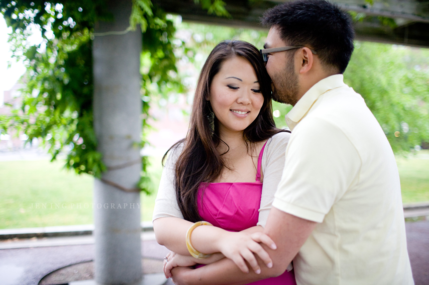 Christopher Columbus Park engagement - couple kissing under arch