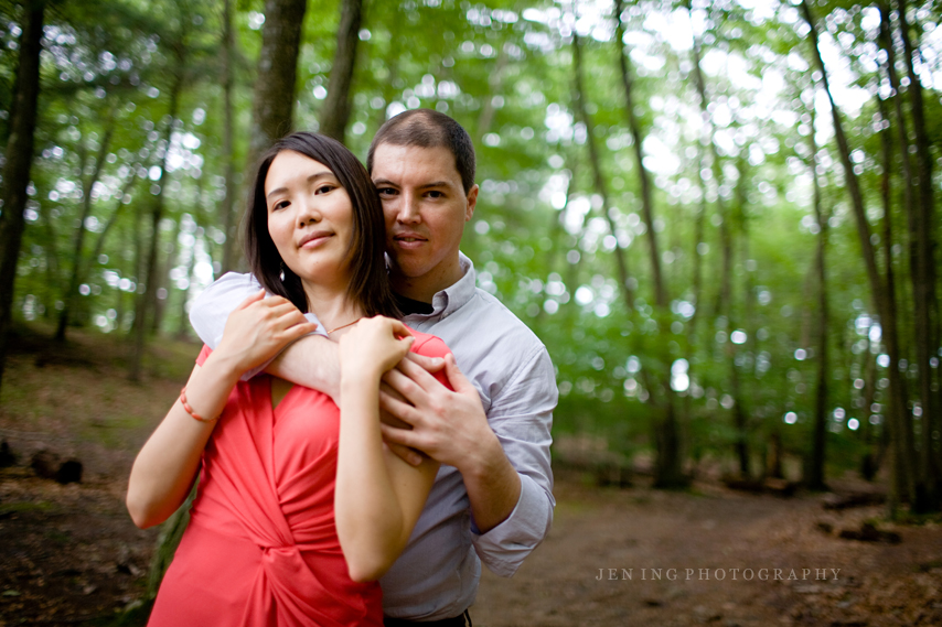 engagement session in the woods - couple among trees