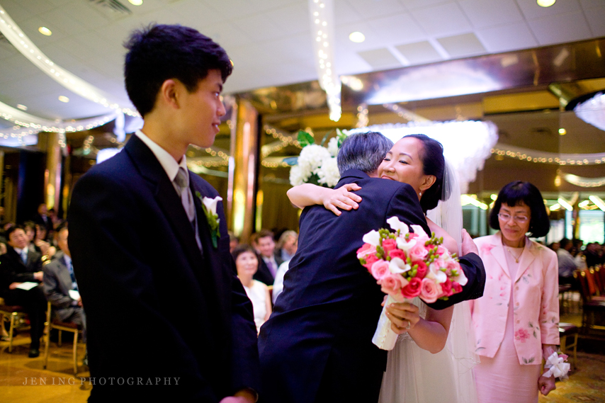 Indoor New York wedding - bride hugging father